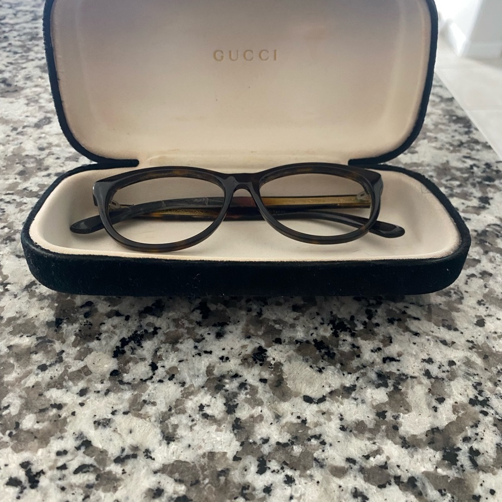 Brown colored Gucci frame with case.